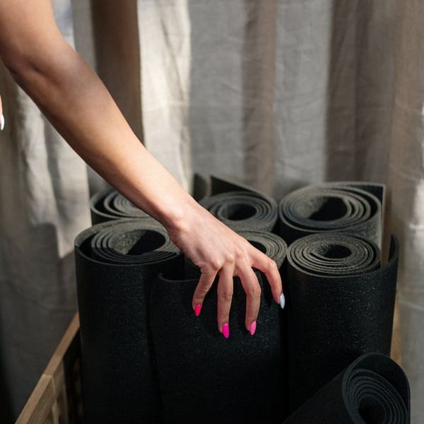 Detailed close-up of yoga practitioner hands on mat.